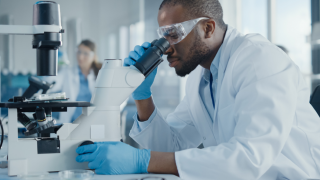 Man looking into microscope