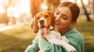 Woman smiling with beagle dog