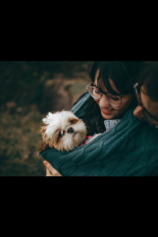 Woman holding her white dog